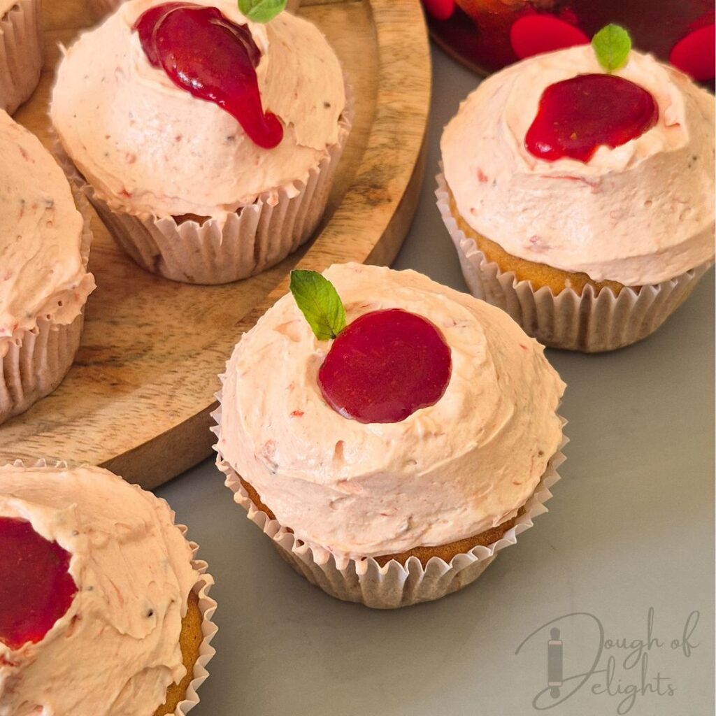 Strawberry compote filled top of cupcake