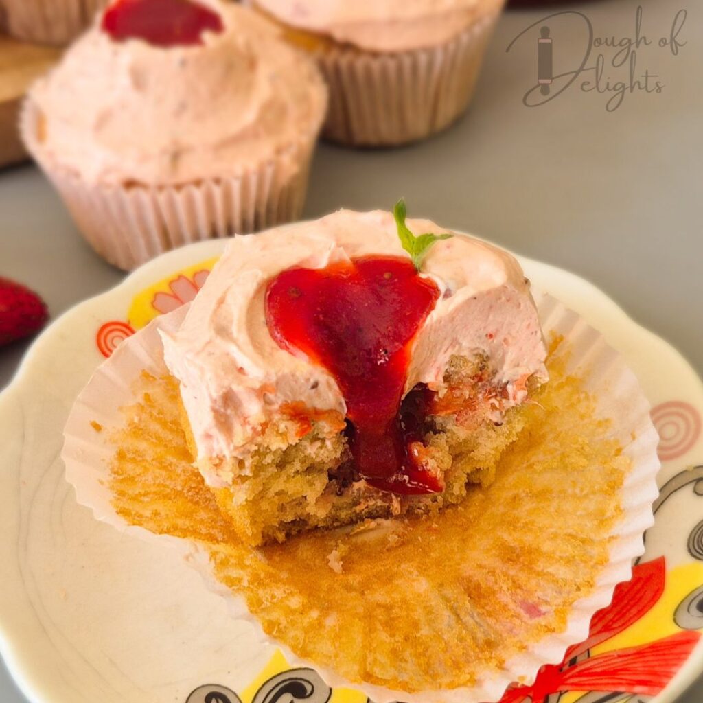 strawberry compote oozing cupcake half