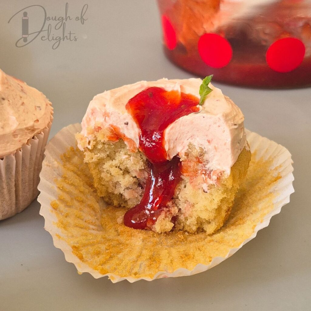 strawberry compote flowing from cupcake