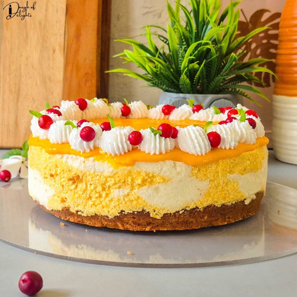 Easy Eggless mango coconut cheesecake with creamy mango swirls and biscuit crust