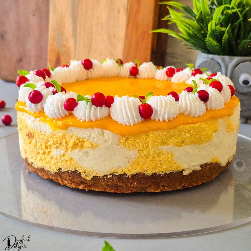 Eggless mango coconut cheesecake with creamy mango swirls and biscuit crust