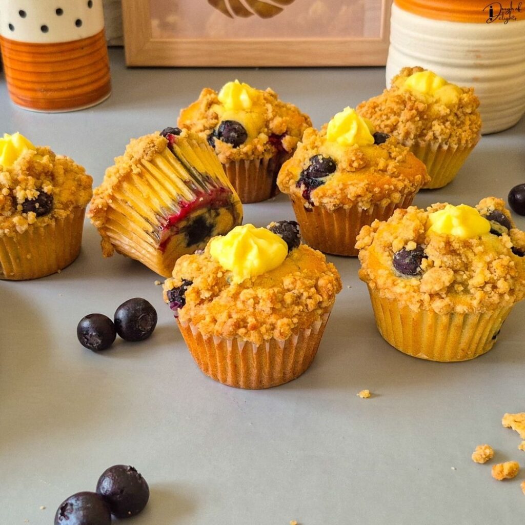 Blueberry Custard Crumble Muffins topped with buttery crumble and filled with creamy vanilla custard