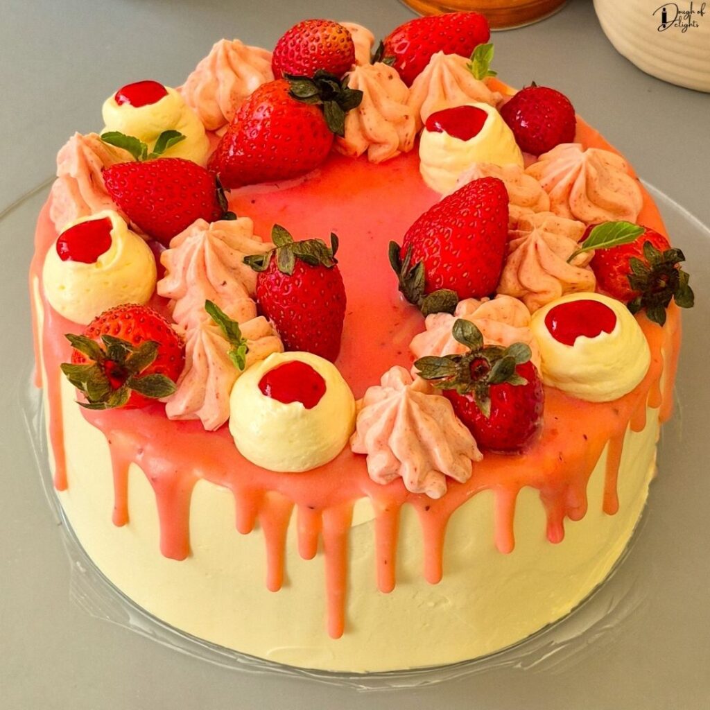 a Strawberry Layer Cake with fresh strawberries, white chocolate drizzle, and mint leaves.