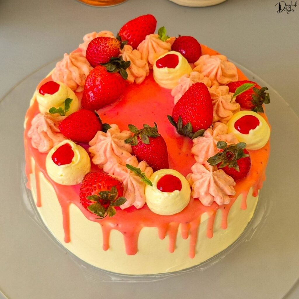a homemade Strawberry Layer Cake with fluffy sponge, strawberry syrup, and silky buttercream.