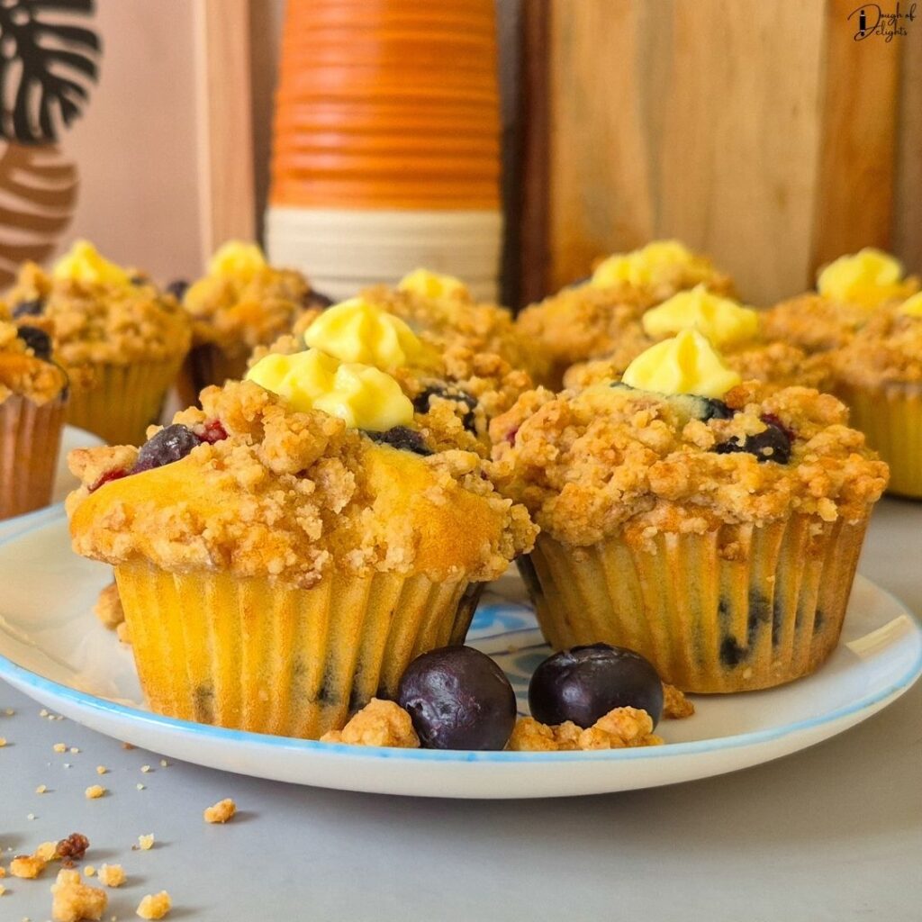 Blueberry Custard Crumble Muffin showing the soft crumb, juicy blueberries, crunchy crumble topping, and vanilla custard filling