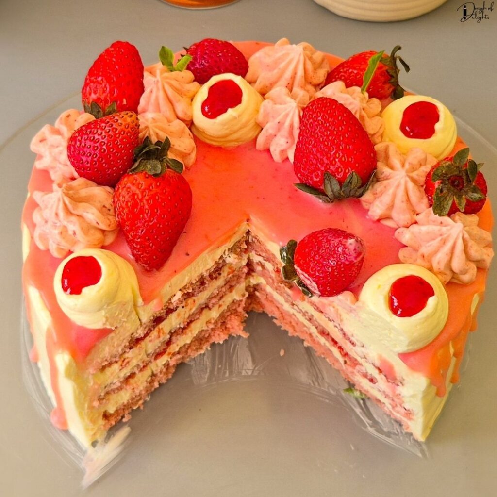 Strawberry Cake decorated with Swiss meringue buttercream, fresh strawberries, white chocolate, and mint leaves.