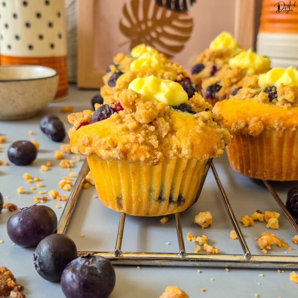 Warm Blueberry Custard Crumble Muffins with a crisp crumble topping and smooth vanilla custard centre.