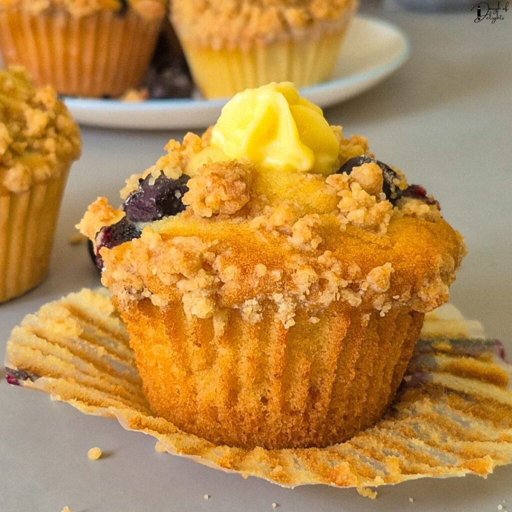 Blueberry muffin topped with blueberries and buttery crumble