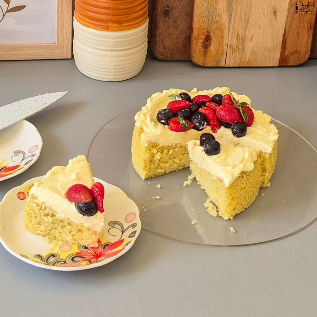 A forkful of soft Coconut Sponge Cake with buttercream and juicy strawberries.