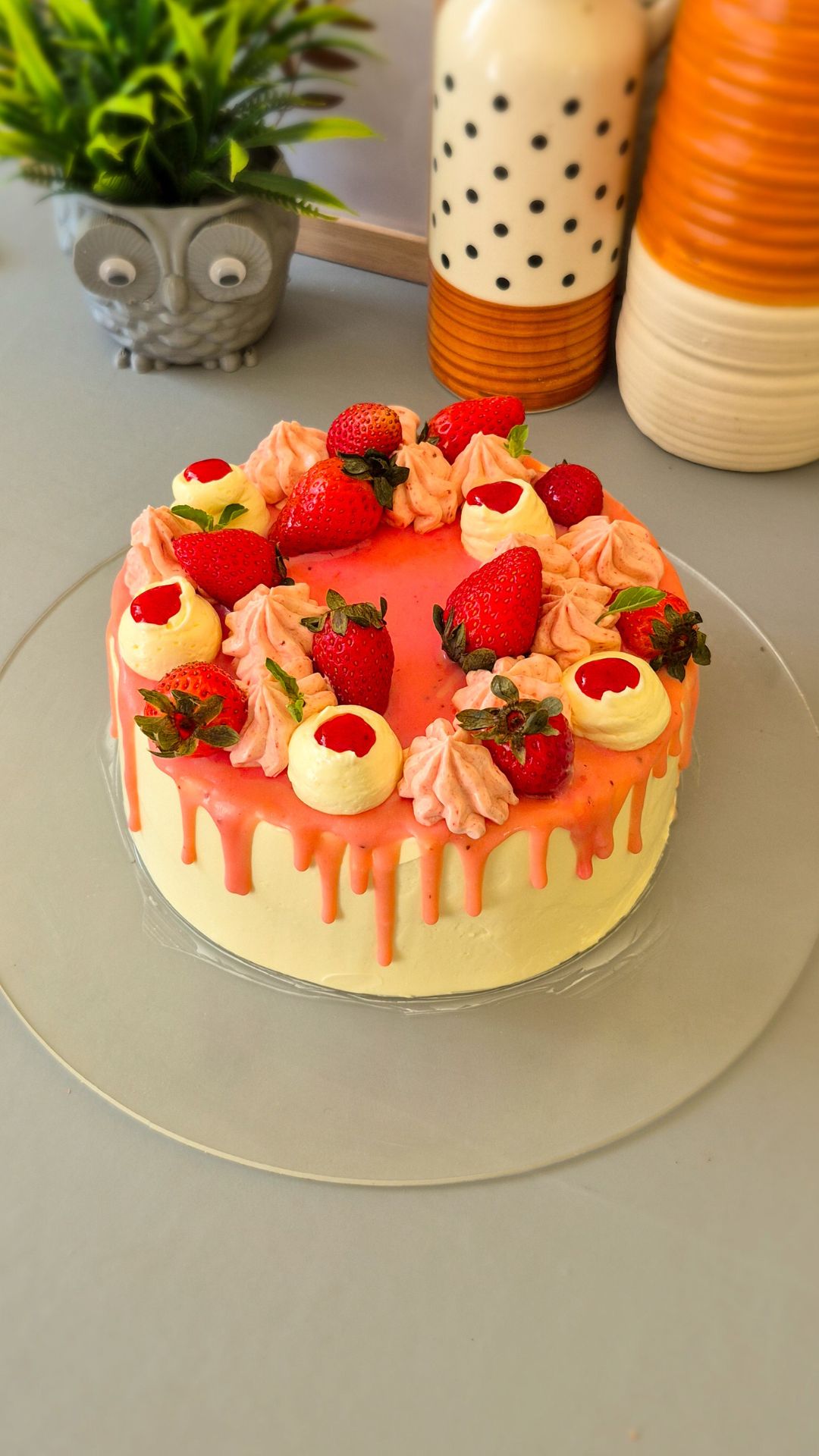 Fresh Strawberry Layer Cake decorated with Swiss meringue buttercream, fresh strawberries, white chocolate, and mint leaves.